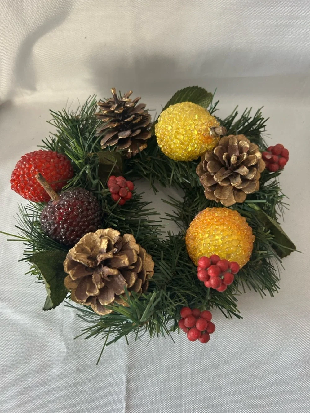 VTG artificial wreath/candle ring w/faux fruit, pinecones, and red berries.